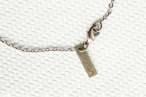 ORGADA's White Wisdom necklace hung and photographed on a white background in close-up of the lobster clasp closure