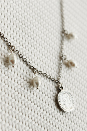 ORGADA's White Wisdom necklace hung and photographed on a white background in close-up