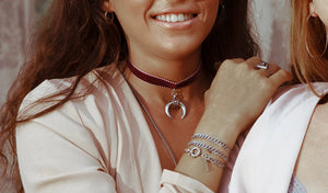 a model wearing Orgada's Maroon Gypsy Luna Choker that is made with a soft velvet strap and a moon pendant